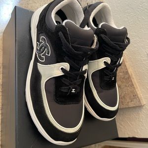 Used black and white Chanel sneaker sized 9 1/2 .